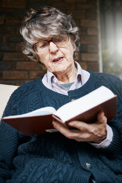 istock Senior woman in spectacles reading book looks irritated 1031880024