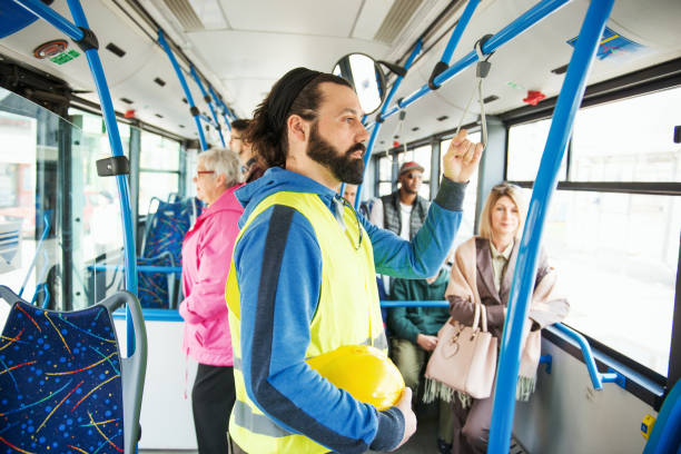 istock Blue collar worker and business people in commuter bus 1031880056