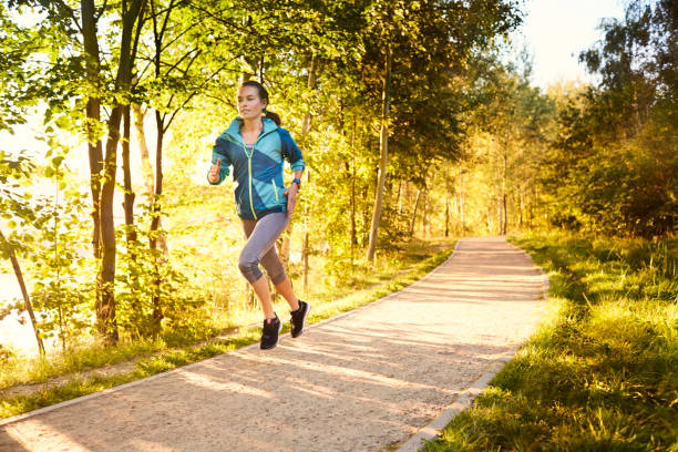 istock Female athlete running in the park 1031880124