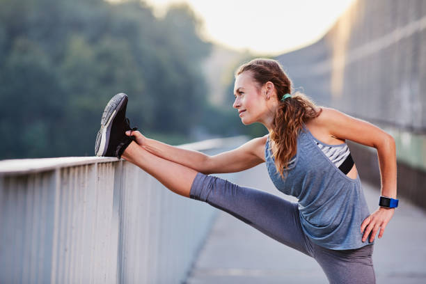 istock Female athlete stretching legs after running 1031880288