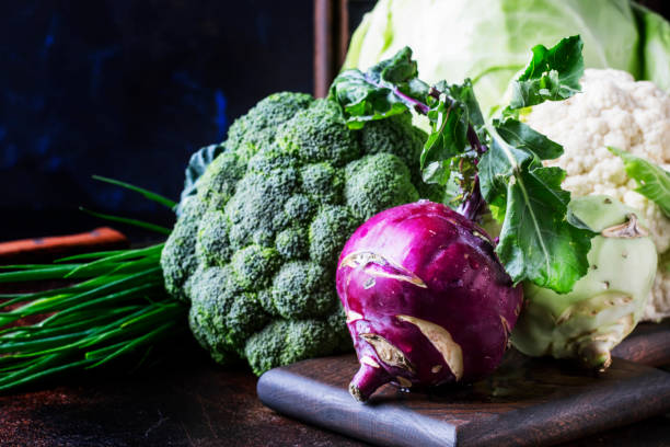 Different kinds of cabbage such as white cabbage, cauliflower, broccoli, kohlrabi Different kinds of cabbage such as white cabbage, cauliflower, broccoli, kohlrabi on dark table, autumn harvest, selective focus cruciferous vegetables stock pictures, royalty-free photos & images