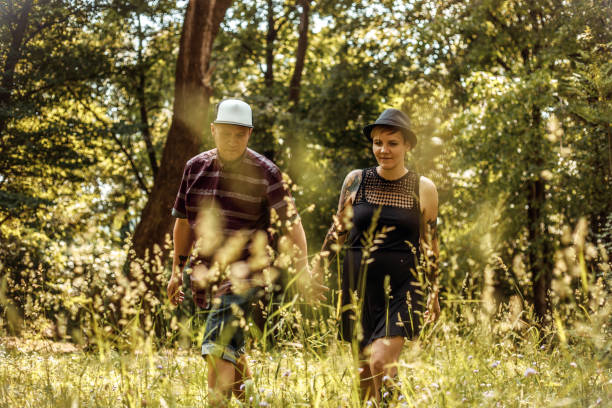 istock Young Couple Holding Hands and Walking Thru Meadow 1031886028