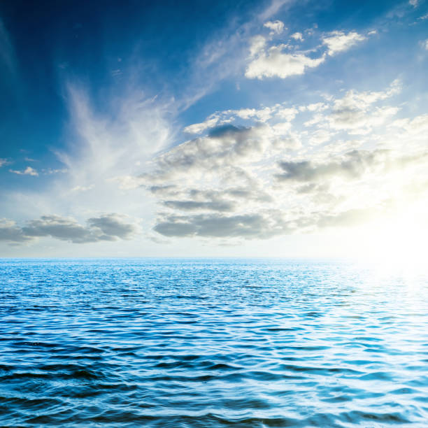 istock sunset in low dark clouds over blue sea 1031889408
