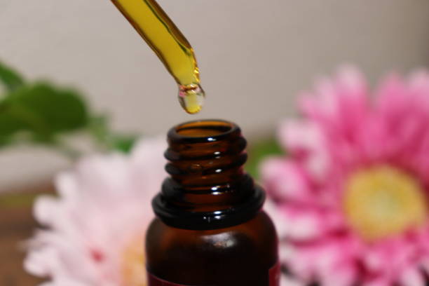 istock Eyedropper from oil bottle and flower 1031890620