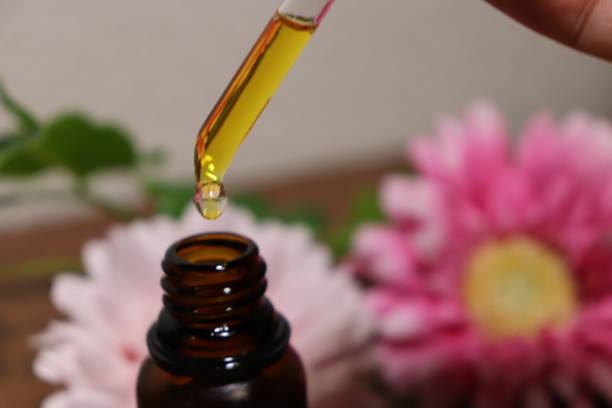 istock Eyedropper from oil bottle and flower 1031890644
