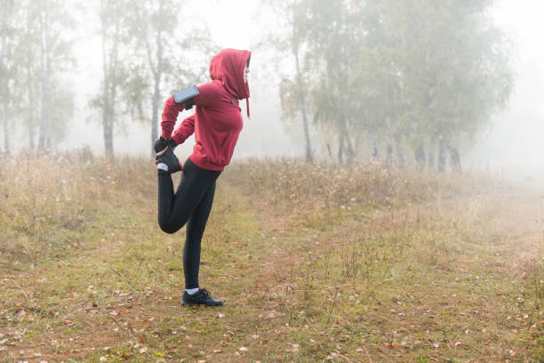 istock Running stretching - woman runner doing exercises in the Park. 1031893736