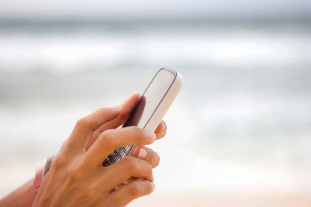 Females hand typing message on smartphone