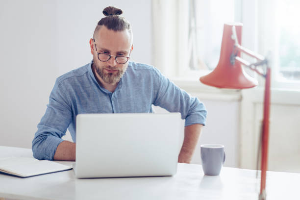 istock Young businessman working on laptop 1031896140