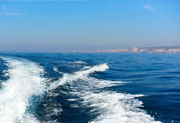 wavy trail on the mediterranean sea after vessel,  spain - island of tabarca imagens e fotografias de stock