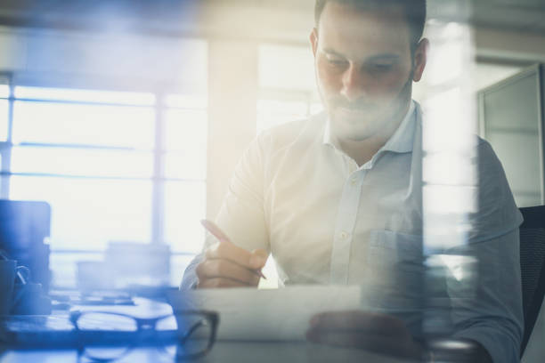 istock Business man writing  document. Business man in office. Portrait. 1031904114