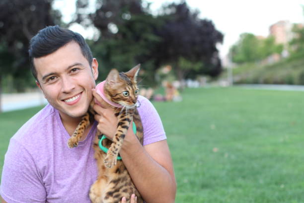 istock Handsome man in the park with his cat 1031905086