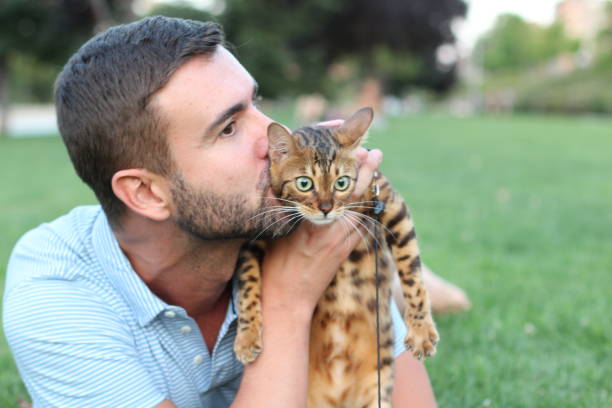 istock Handsome bachelor kissing his pet outdoors 1031905110
