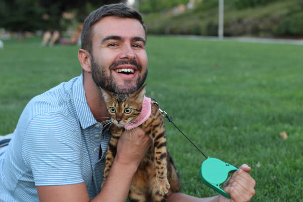 istock Handsome man in the park with his cat 1031905296
