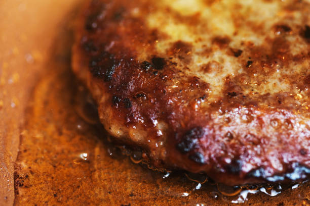 istock Cropped close-up of single juicy hamburger patty 1031908476