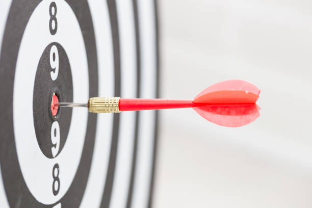 istock Target dart arrow hitting in the center of dartboard 1031908782