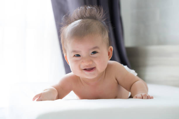 istock Smiling baby boy on the bed at home 1031908934