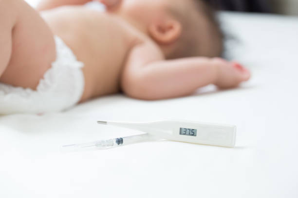istock Fever, Baby sick and measuring electric thermometer 1031910088