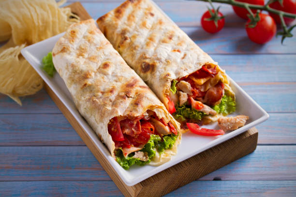 istock Chicken bacon wraps with tomatoes, lettuce and cheese. Tortilla, burritos, sandwiches twisted rolls 1031913006