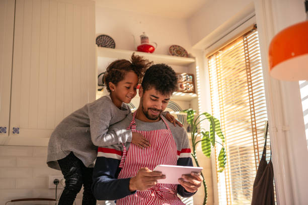 istock Dad and daughter cooking together 1031913986
