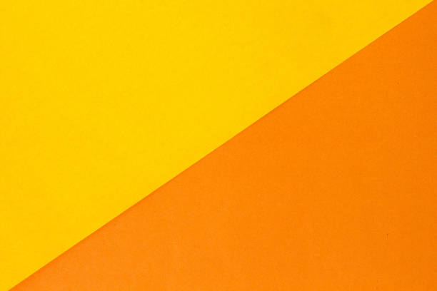 istock paper color yellow, orange abstract background 1031916240