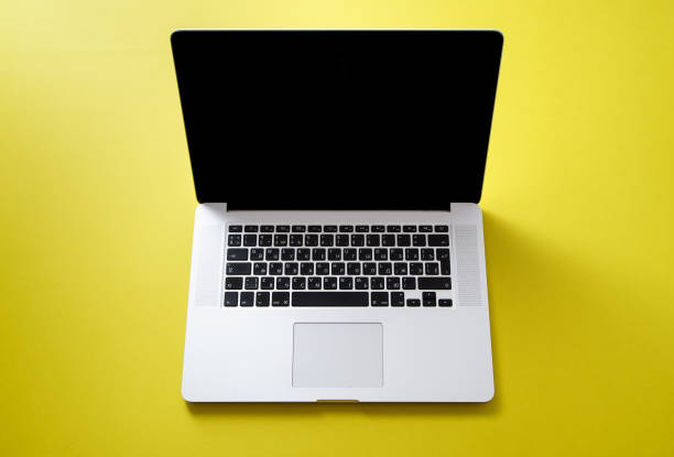 istock Flat lay with laptop on bright olive yellow background with copy space 1031916780
