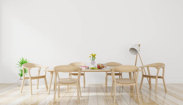istock Bright spacious dining room with wooden big table and lamp with white wall background 1031917258