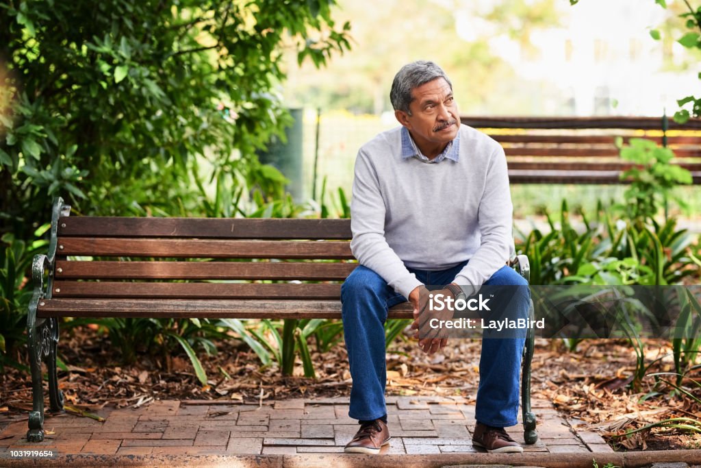 The park is where he comes to ponder a while Shot of a mature man looking thoughtful outdoors Men Stock Photo