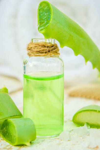 istock Aloe Vera extract in a small bottle and pieces on the table. Selective focus. 1031920004