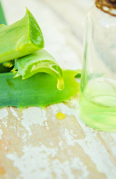 istock Aloe Vera extract in a small bottle and pieces on the table. Selective focus. 1031920036