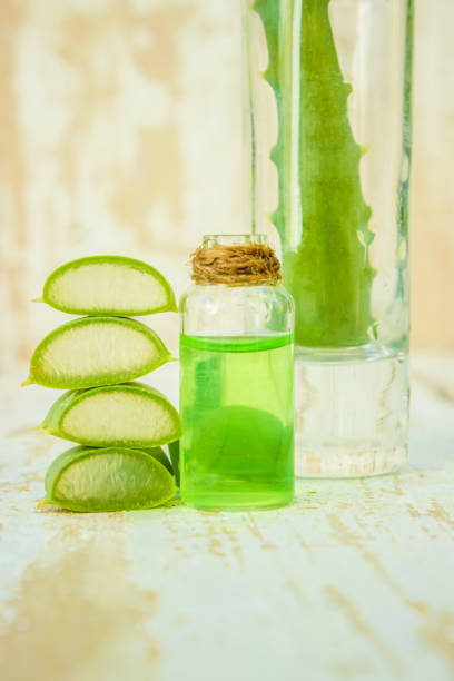 istock Aloe Vera extract in a small bottle and pieces on the table. Selective focus. 1031920064