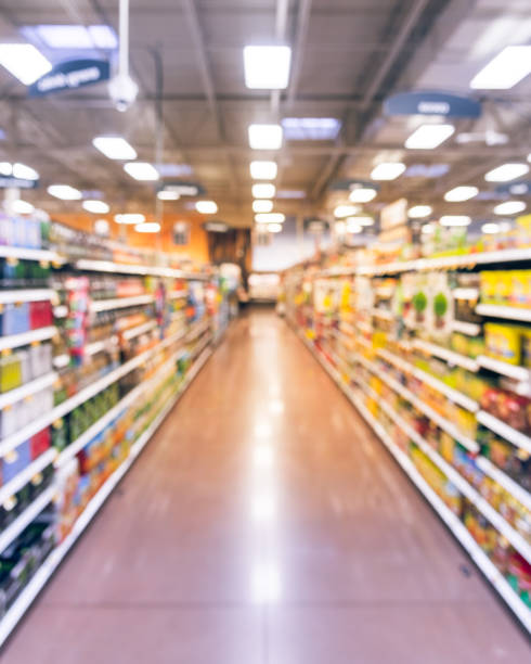 Filtered tone blurry background bottled tea, energy drinks shelves at grocery store