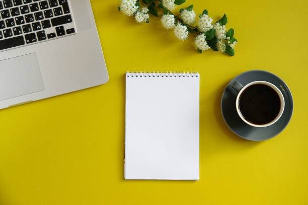 istock Flat lay mock up with laptop, notebook and coffee cup on bright olive yellow background with copy space 1031931988