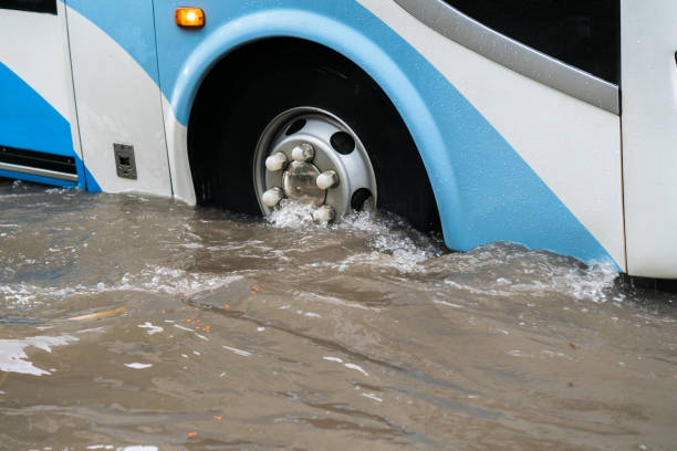 istock Bus splashes through a large puddle on a flooded street 1031933308