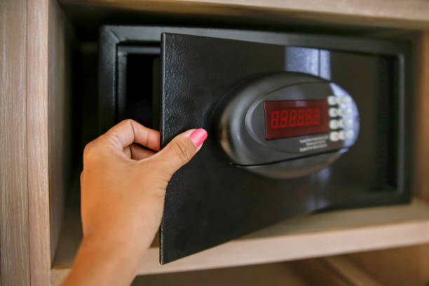 Females tourist securing valuables inside safety deposit box hotel