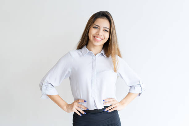 istock Smiling lovely lady standing and keeping hands on hips 1031940304