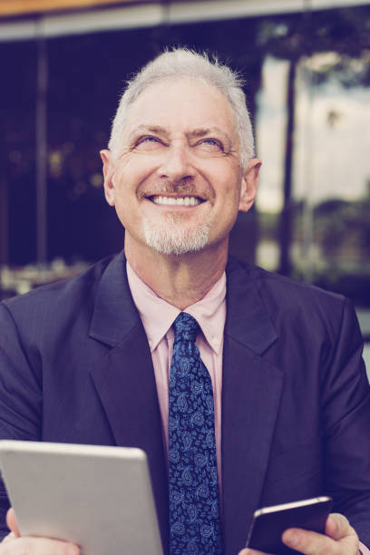 istock Dreamy Boss Using Tablet and Smartphone Outdoors 1031941282
