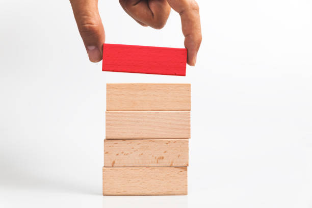 istock Hand put wooden blocks on the stack of wooden blocks 1031941506