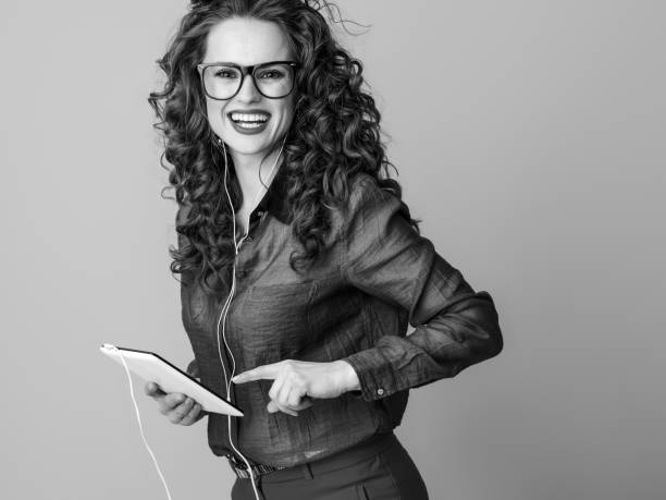 istock happy woman in headphones isolated on using tablet PC 1031945768