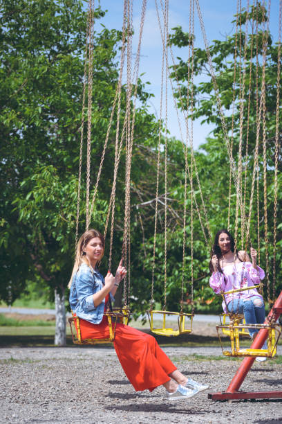istock girls at the carrousel 1031949456