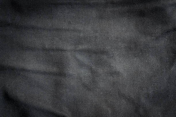 istock Striped textured used black jeans denim fabric background 1031949570