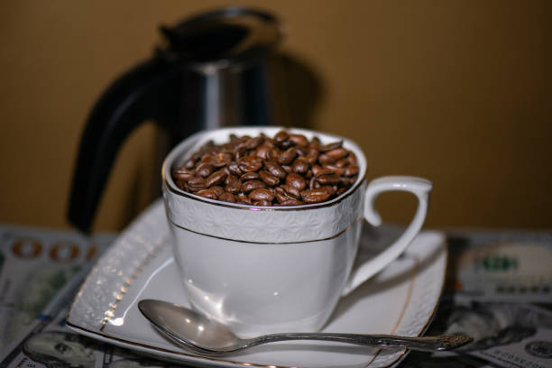 istock Coffee beans in a Cup on a Golden background 1031952098