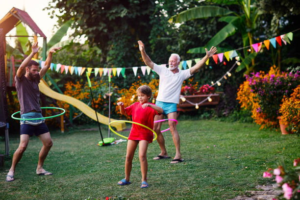 istock Multi generation family hula hooping in backyard 1031953058