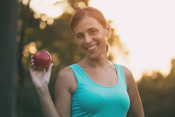 istock Sporty woman holding apple 1031955268
