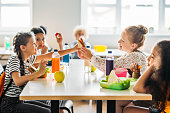 adorable schoolgirls taking lunch at school cafeteria