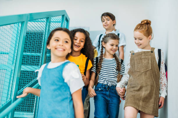 istock group of happy classmates walking down stairs at school 1031956196