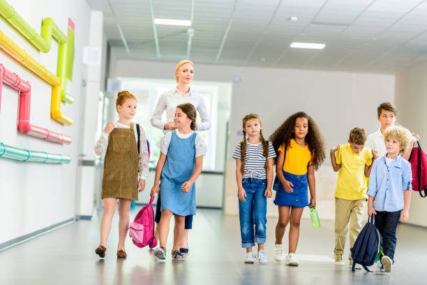 istock group of happy multiethnic classmates walking by school corridor 1031956216