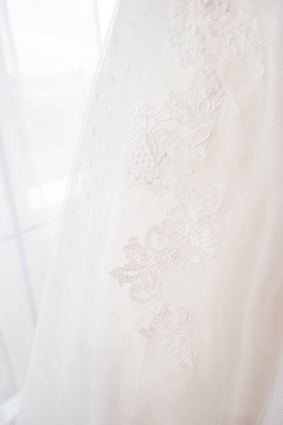 istock Bride's dress with embroidered elements and beads. Bridal traditional symbolic accessory for wedding ceremony. 1031956262