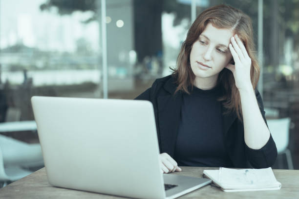 istock Pensive Woman Looking at Laptop in Deep Thoughts 1031956398