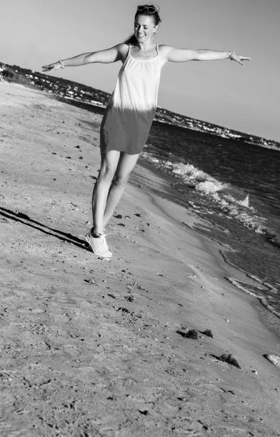 istock smiling fit woman on beach in evening having fun time 1031957168