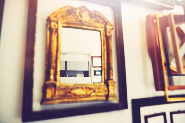 In the realm of picture frames - many old picture frames in a frame workshop